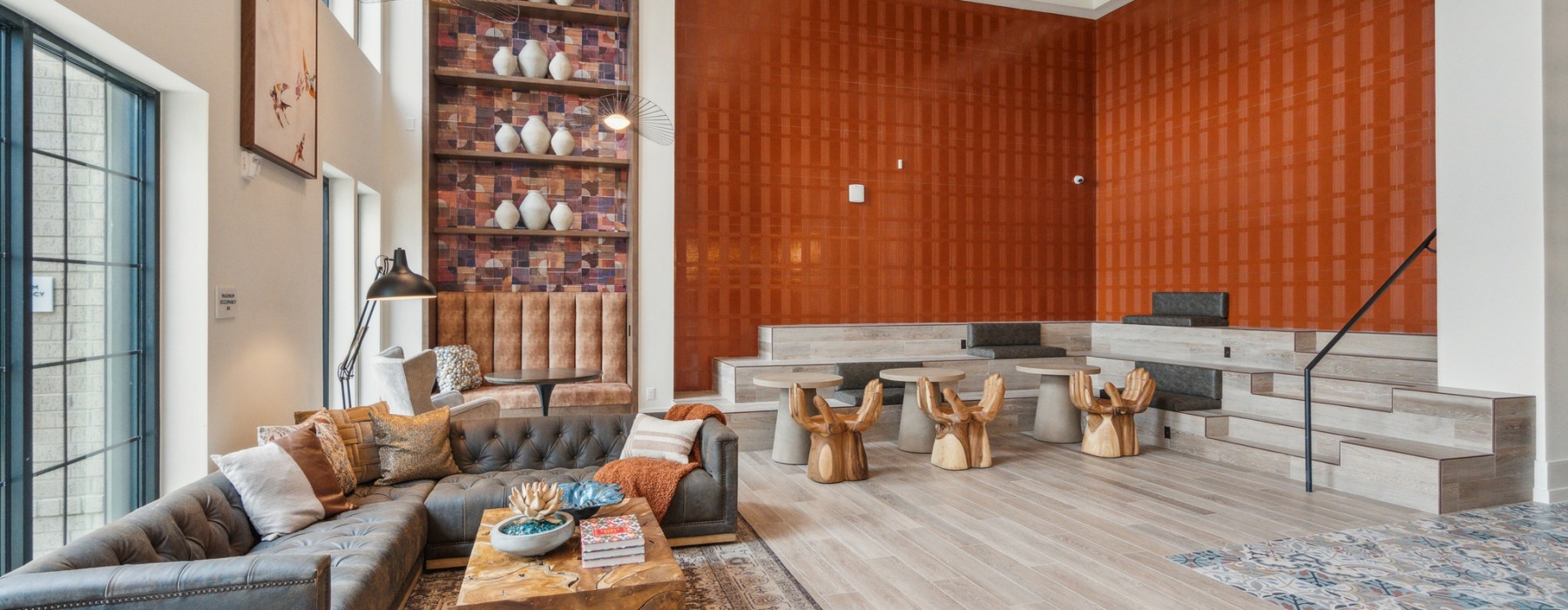 spacious clubhouse with high ceilings, stylized lighting and areas to socialize
