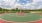 Vibrant outdoor basketball court with lush greenery and a bright blue sky backdrop at Elina in Easton Park