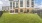 Contemporary apartment building with lush green lawn and fenced seating area in Easton Park