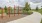 Inviting outdoor space featuring a modern walking path, lush greenery, and recreational area with sports facilities near elegant residential apartments in Easton Park