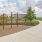 Inviting outdoor space featuring a modern walking path, lush greenery, and recreational area with sports facilities near elegant residential apartments in Easton Park