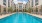 Luxurious apartment complex featuring a sparkling central swimming pool surrounded by elegant modern architecture and relaxing lounge chairs in Austin