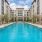 Luxurious apartment complex featuring a sparkling central swimming pool surrounded by elegant modern architecture and relaxing lounge chairs in Austin